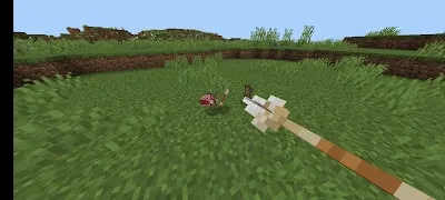 Arrow aimed at items on grassy terrain