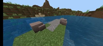 Gravel path leads into a riverbank scene.