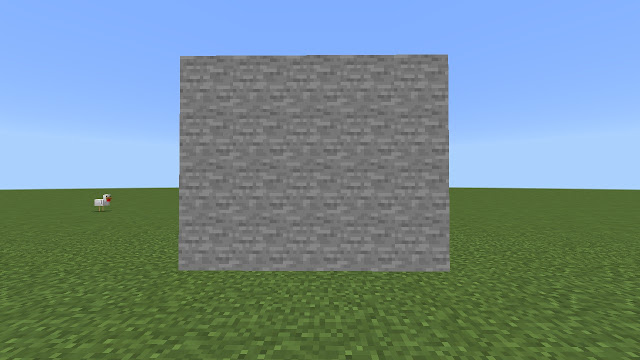 Stone-like block in grassy field.