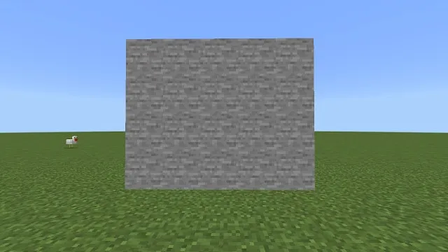 Stone-like block in grassy field.