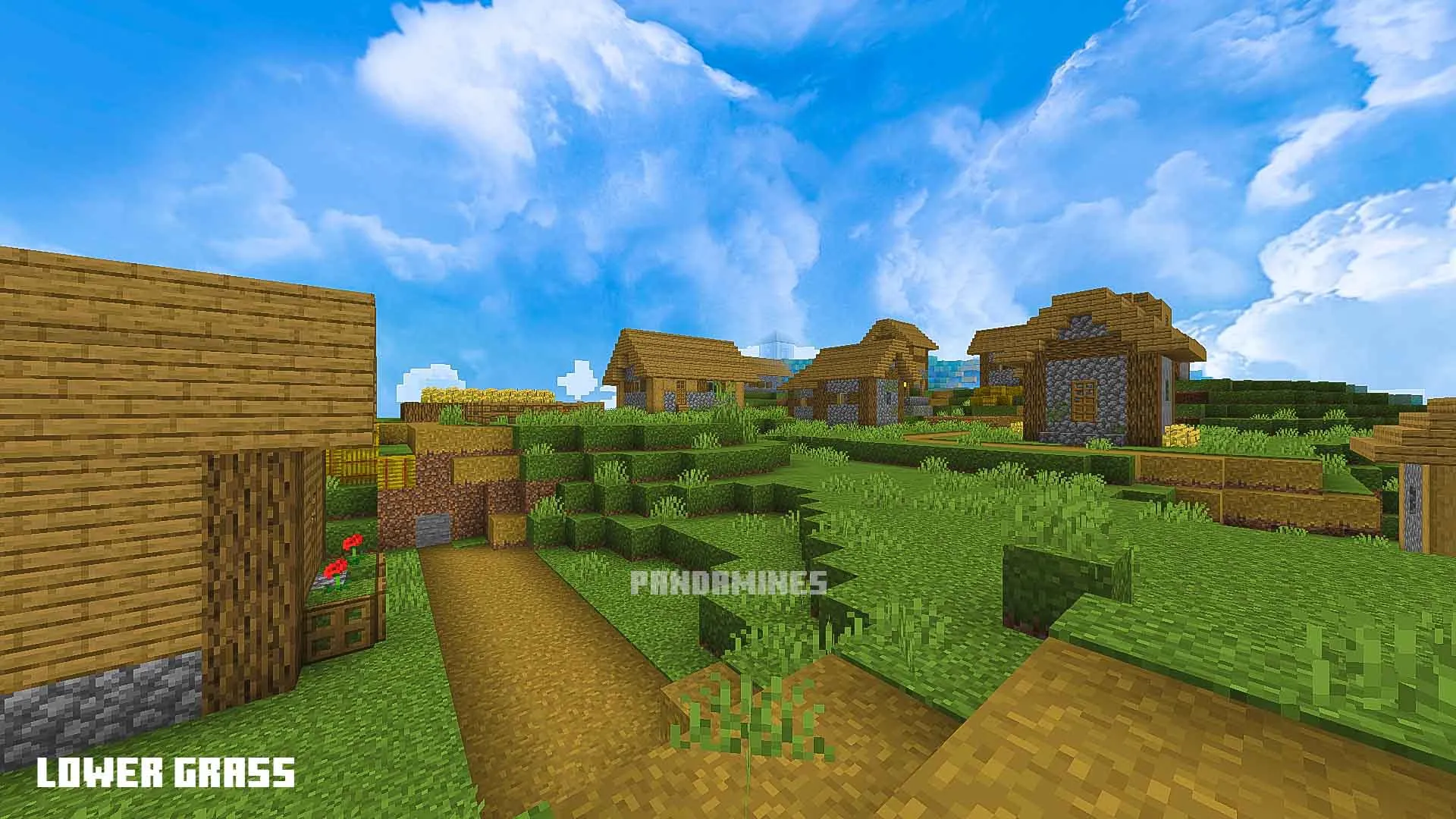 Pixelated village with lush green grass.