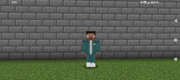 Character in teal tracksuit by brick wall.