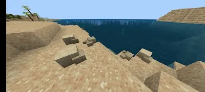 Blocky shoreline with sand and water