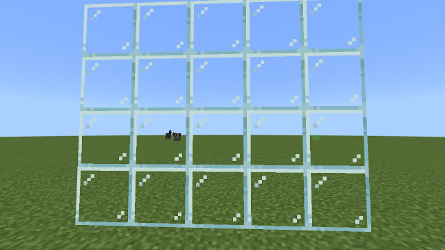 Transparent glass block in a grassy field.