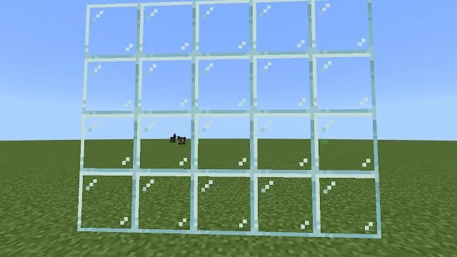 Transparent glass block in a grassy field.