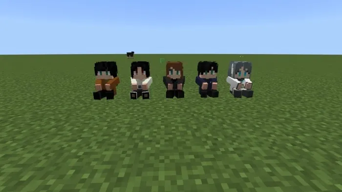Five pixelated dolls on grass.