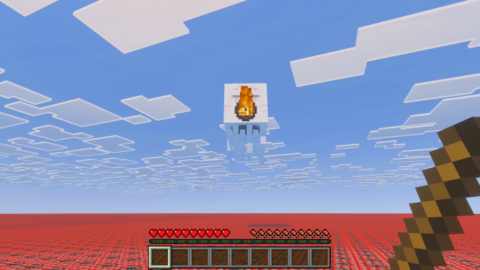 Screenshot of a ghast shooting a fireball at the player, who is holding a stick. The terrain is entirely made of TNT blocks.