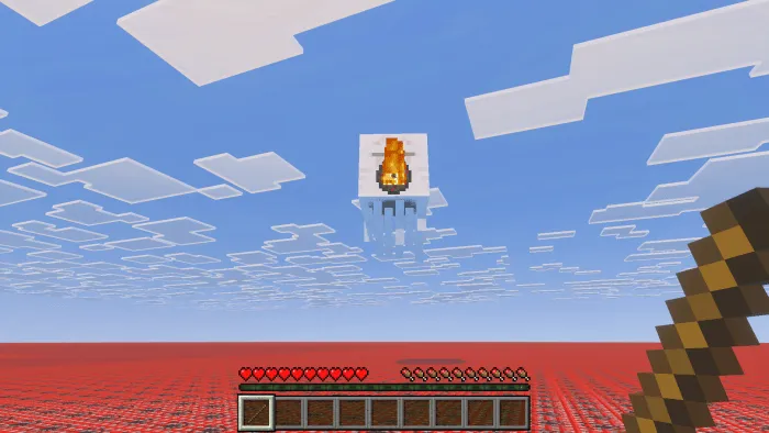 Screenshot of a ghast shooting a fireball at the player, who is holding a stick. The terrain is entirely made of TNT blocks.