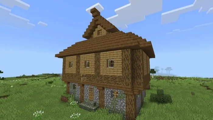 Wooden house on a grassy field.