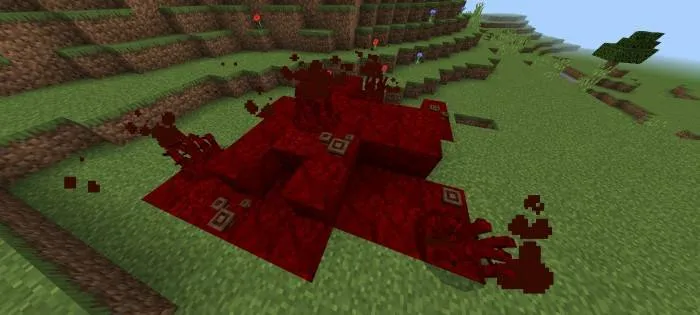 Red organic growth on grassy terrain.