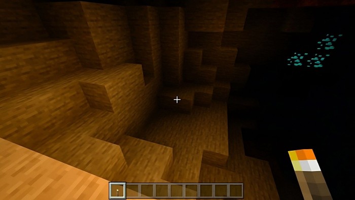 Cave illuminated by torchlight.