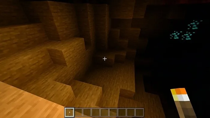 Cave illuminated by torchlight.