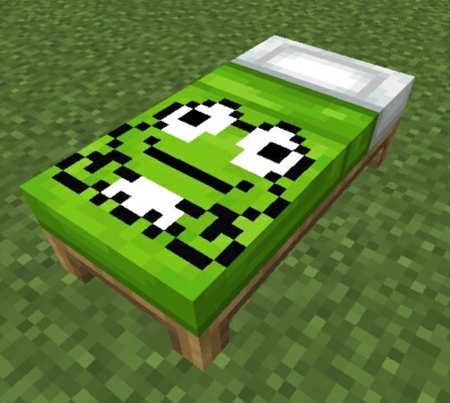 Green bed with pixel art face design.