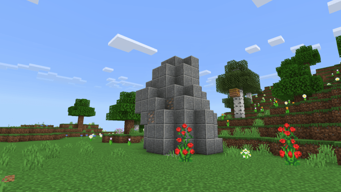 Stone structure with flowers in a field.