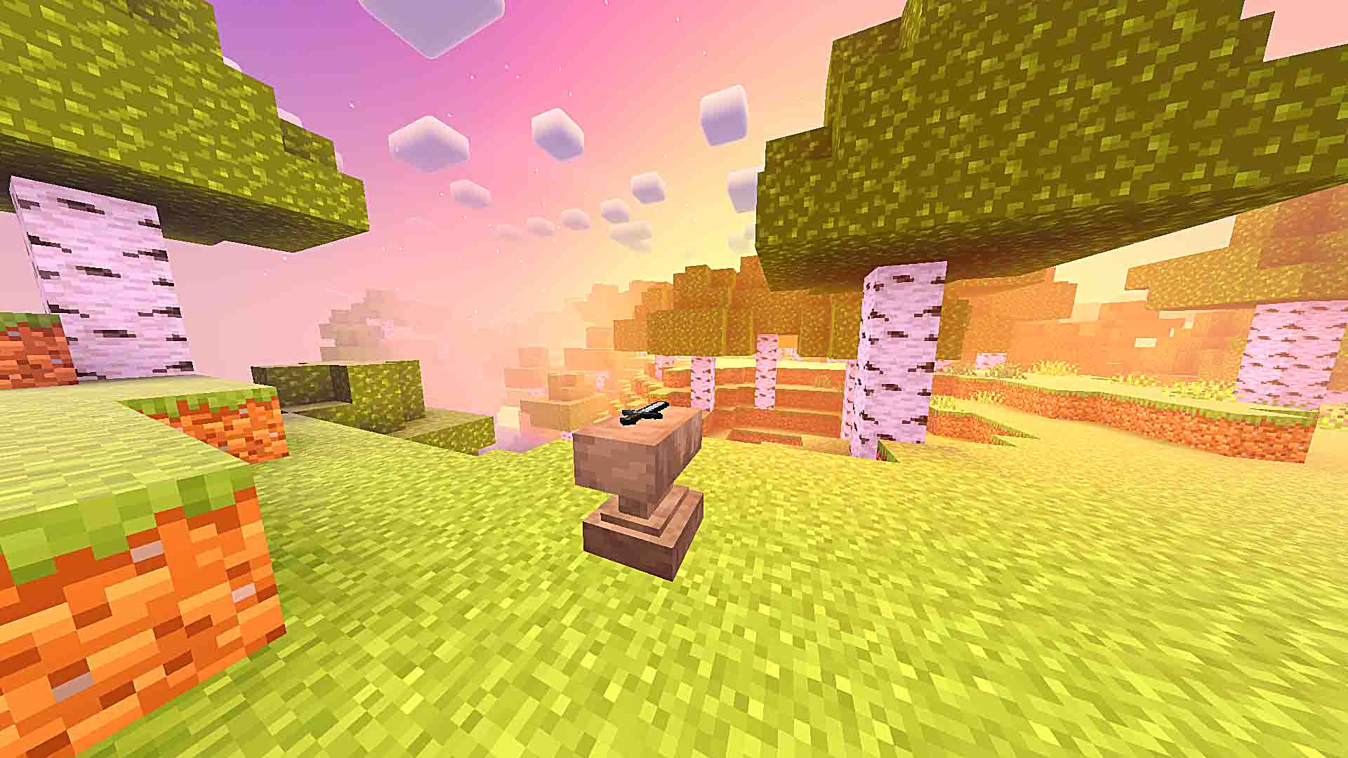 Anvil on grass in a vibrant sunset.