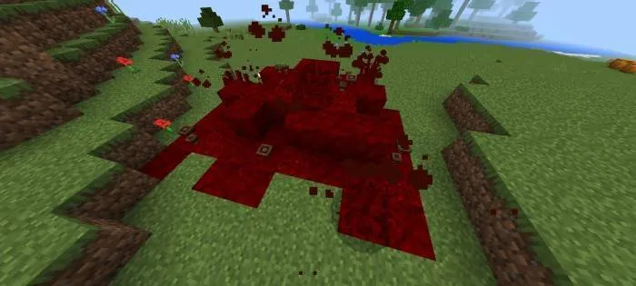 Red, organic infestation on grassy terrain.
