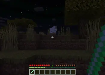 Player holding a lightsaber at night.