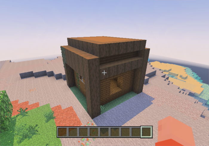 Blocky wooden structure on sandy terrain.