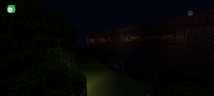 Dark brick building with trees at night.