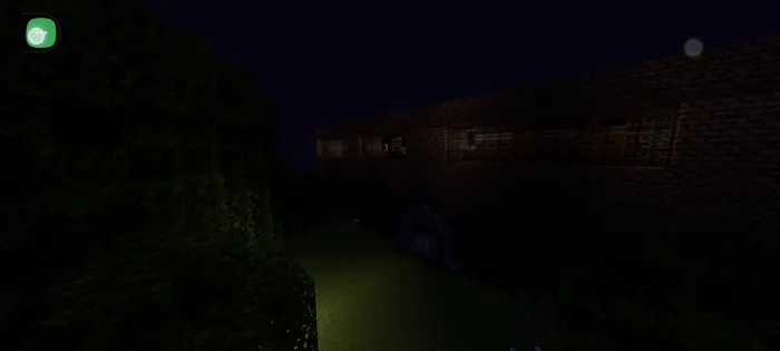 Dark brick building with trees at night.