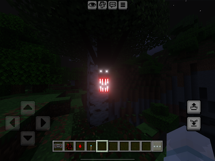 Glowing eyes and mouth on a tree.