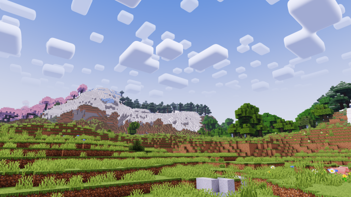Blocky landscape with trees and clouds.