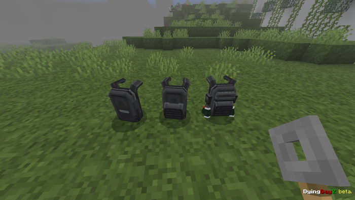 Three walkie-talkies on grass.