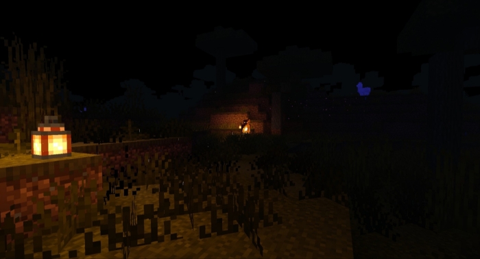 Dark landscape with a glowing lantern.