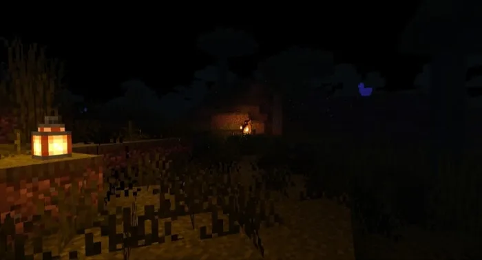 Dark landscape with a glowing lantern.