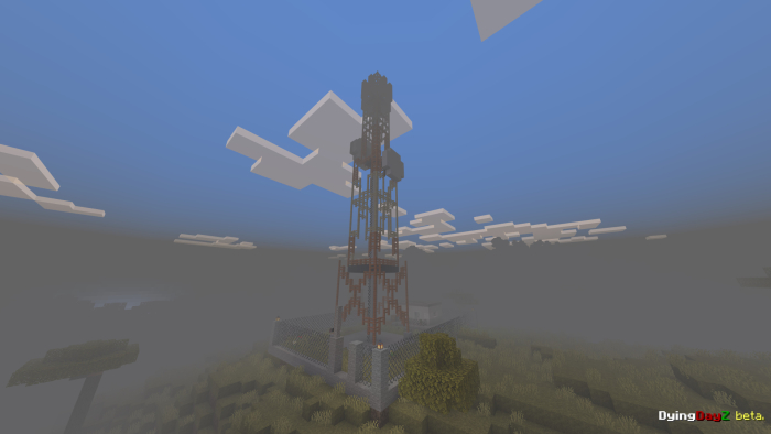 Tall tower structure in a foggy landscape.