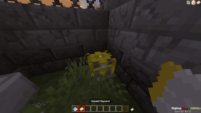 Yellow keycard in grassy corner.