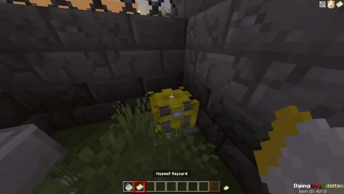 Yellow keycard in grassy corner.
