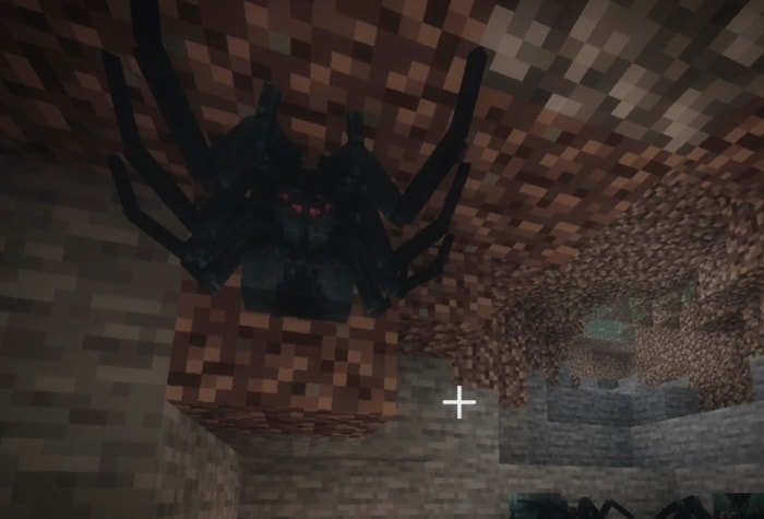 Giant spider hanging from cave ceiling.