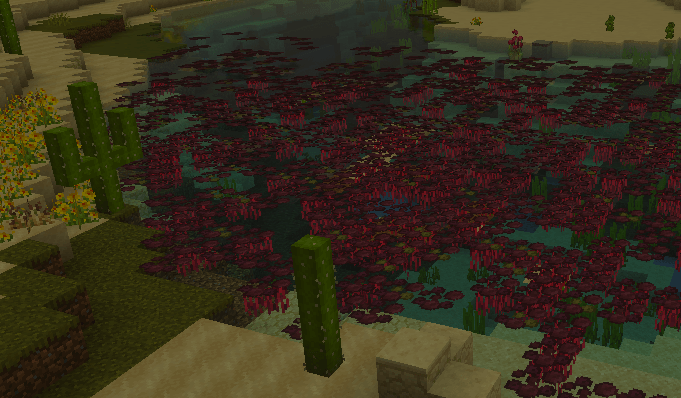 Desert pond with red foliage and cacti.
