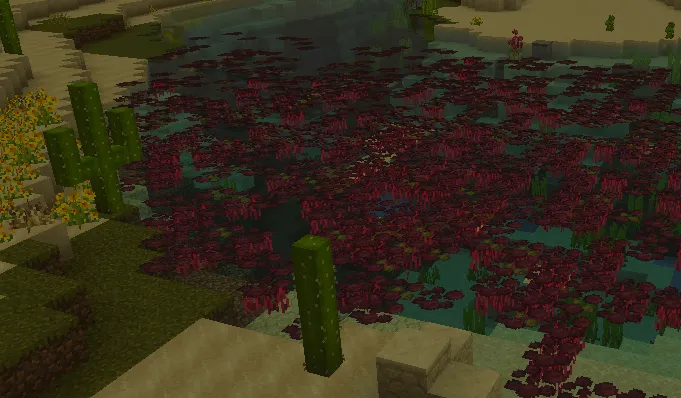 Desert pond with red foliage and cacti.