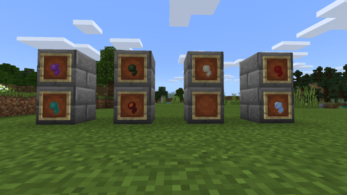 Four stone blocks with colorful items.