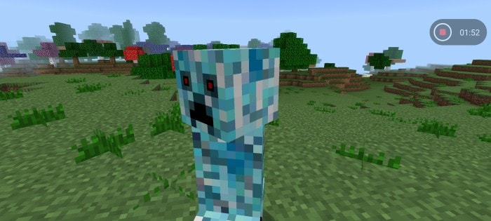 Pixelated blue creature in a grassy field.