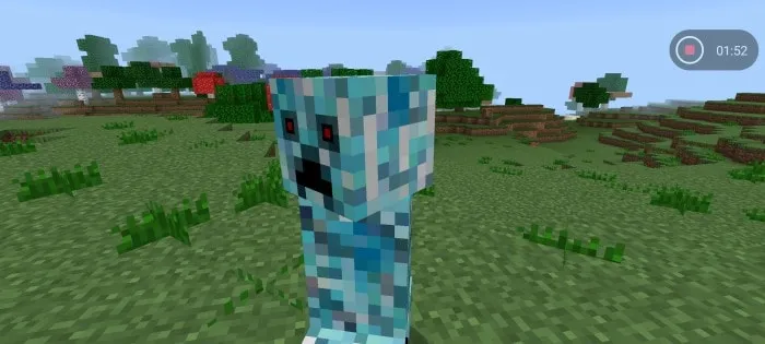 Pixelated blue creature in a grassy field.