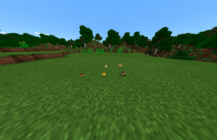 Chickens on grassy field in game.