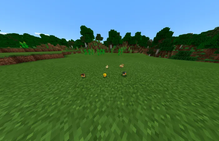 Chickens on grassy field in game.