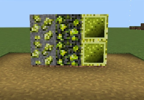 Four textured Brazilian ore blocks on grass