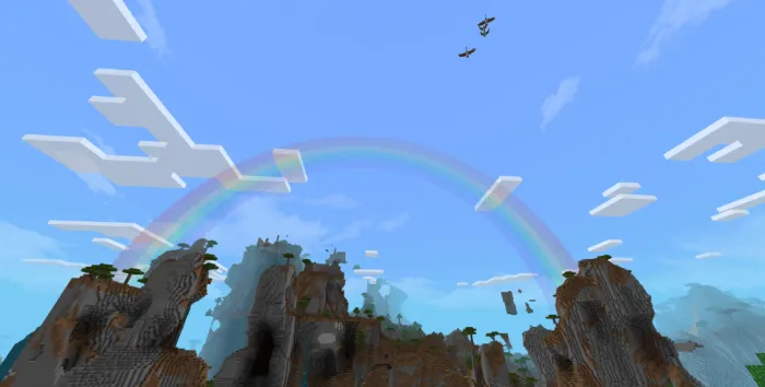 Rainbow and clouds over blocky mountains