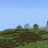 Three small houses on a grassy hillside