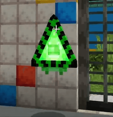 Green triangle character on tiled wall.