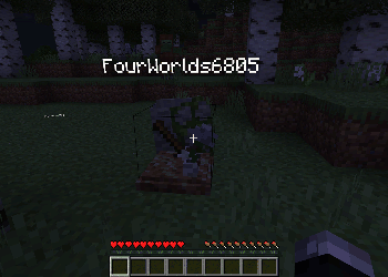 Player gravestone with stored items at night