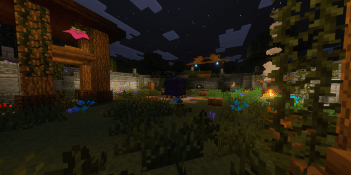 Nighttime garden scene with torches.