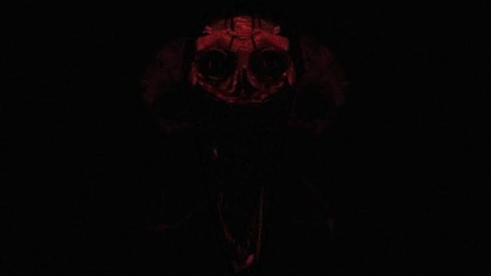 Sinister red creature face in darkness
