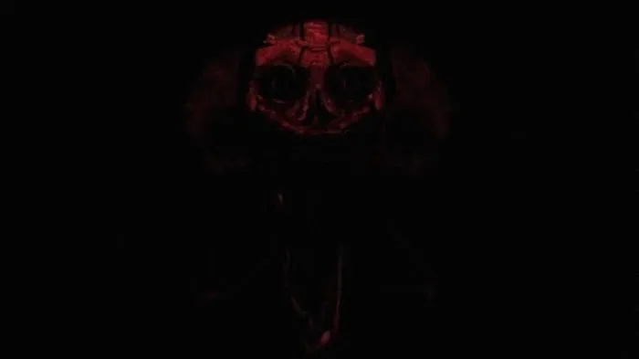Sinister red creature face in darkness