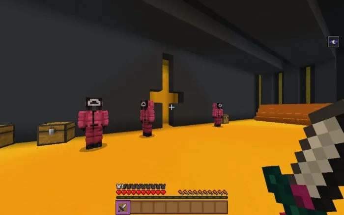 Three masked guards in a golden room