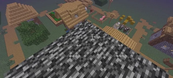 Aerial view of pixelated village and farms.